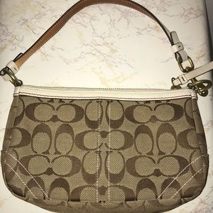 Coach clutch with red flower.